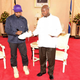 Kanye West autographs a pair of his sneakers as a gift to Uganda’s President Yoweri Museveni, on Oct. 15, 2018, at State House in Entebbe, Uganda. Museveni said he and West held “fruitful discussions” about promoting tourism and arts in the East African nation in which the rapper is said to be recording music in a tent.